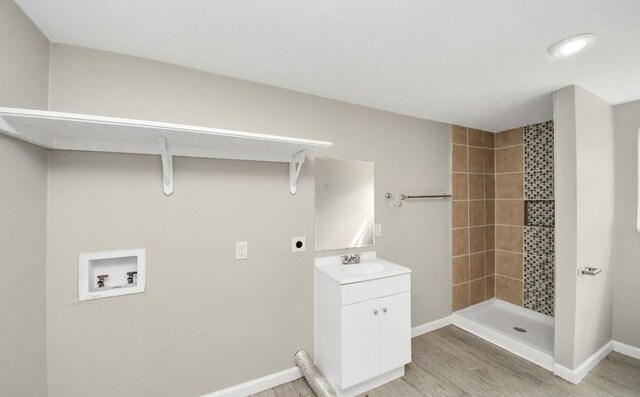 720 Roosevelt St, La Marque, TX 77568 - washroom featuring hookup for an electric dryer, hookup for a washing machine, light wood-type flooring, and baseboards