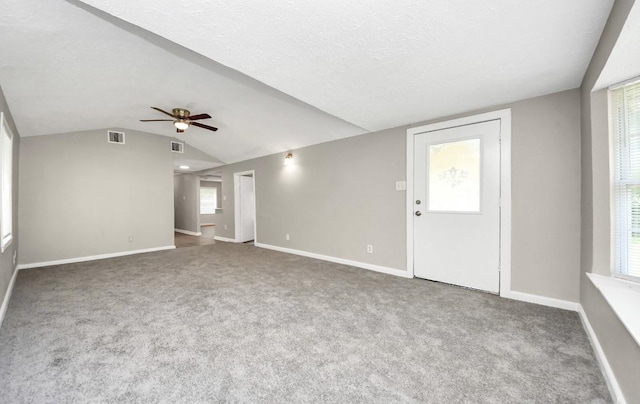 720 Roosevelt St, La Marque, TX 77568 - unfurnished living room featuring ceiling fan, vaulted ceiling, carpet floors, and baseboards