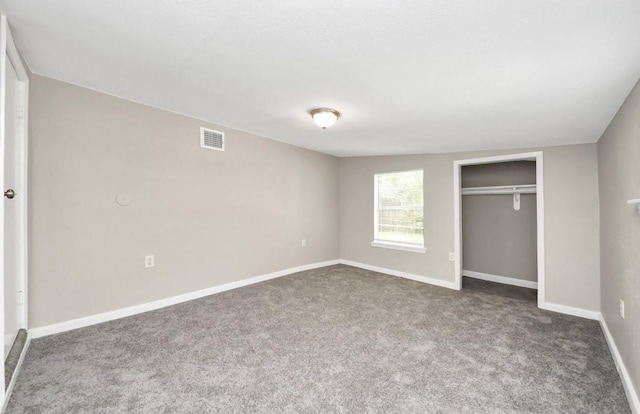 720 Roosevelt St, La Marque, TX 77568 - unfurnished bedroom with dark colored carpet, a closet, and baseboards