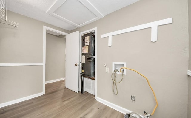 720 Roosevelt St, La Marque, TX 77568 - washroom featuring attic access, hookup for a washing machine, wood finished floors, and baseboards