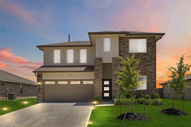 14714 Sweet Water Dr, Baytown, TX 77523 - view of front of house with central air condition unit, driveway, a front yard, an attached garage, and stucco siding