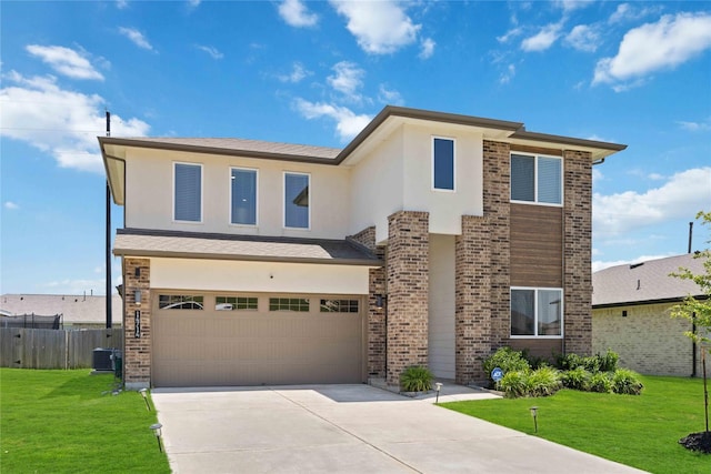 14714 Sweet Water Dr, Baytown, TX 77523 - view of front facade with a garage, concrete driveway, central AC, stucco siding, and brick siding