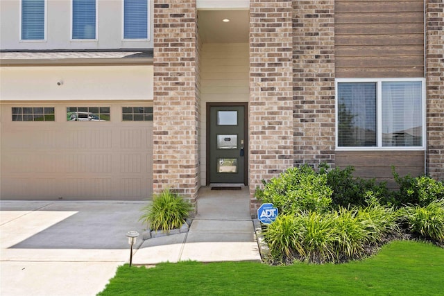 14714 Sweet Water Dr, Baytown, TX 77523 - doorway to property with a garage, brick siding, and driveway