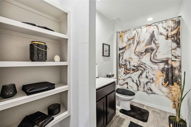 14714 Sweet Water Dr, Baytown, TX 77523 - full bathroom with wood finished floors, toilet, vanity, and shower / bath combo