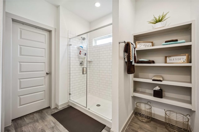 14714 Sweet Water Dr, Baytown, TX 77523 - bathroom with a stall shower, wood finished floors, and baseboards