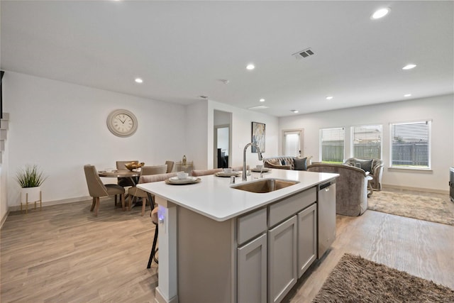 14714 Sweet Water Dr, Baytown, TX 77523 - kitchen featuring a sink, gray cabinetry, open floor plan, dishwasher, and light wood-style floors