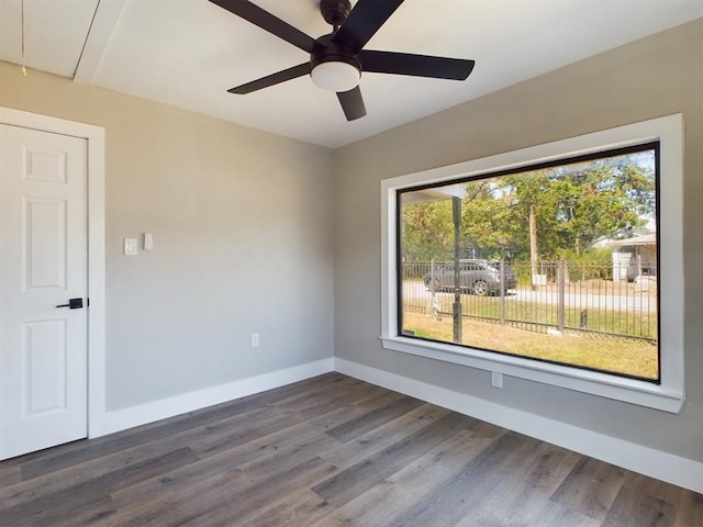 7609 Shotwell St, Houston, TX 77016 - unfurnished room with baseboards, dark wood-style floors, ceiling fan, and attic access