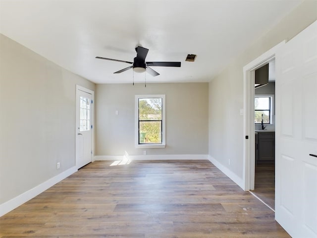 7609 Shotwell St, Houston, TX 77016 - unfurnished room featuring wood finished floors, a sink, ceiling fan, and baseboards