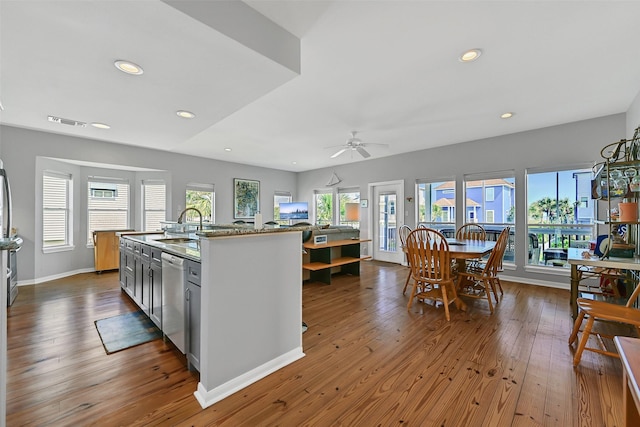 kitchen with dishwasher, wood-type flooring, a sink, recessed lighting, and a ceiling fan