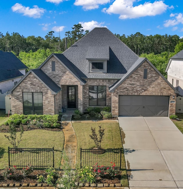 10066 Preserve Way, Conroe, TX 77385 - french provincial home featuring brick siding, a shingled roof, concrete driveway, and a garage