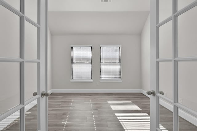 10066 Preserve Way, Conroe, TX 77385 - spare room with lofted ceiling, wood finished floors, and baseboards