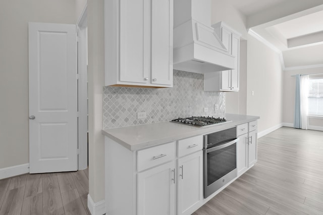 10066 Preserve Way, Conroe, TX 77385 - kitchen with appliances with stainless steel finishes, custom range hood, backsplash, light wood finished floors, and light countertops
