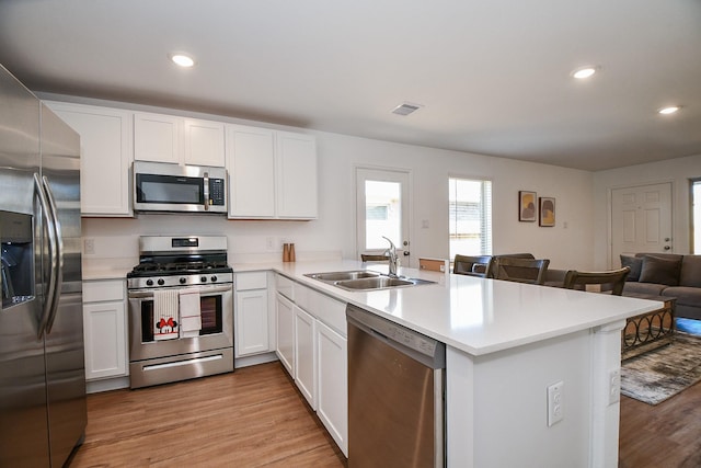 9315 Sierra Point Way, Baytown, TX 77521 - kitchen featuring appliances with stainless steel finishes, open floor plan, a peninsula, a sink, and light countertops