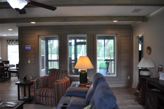 280 Lakewood Cir, Brenham, TX 77833 - living area with beamed ceiling, wood finished floors, plenty of natural light, ceiling fan, and wooden walls
