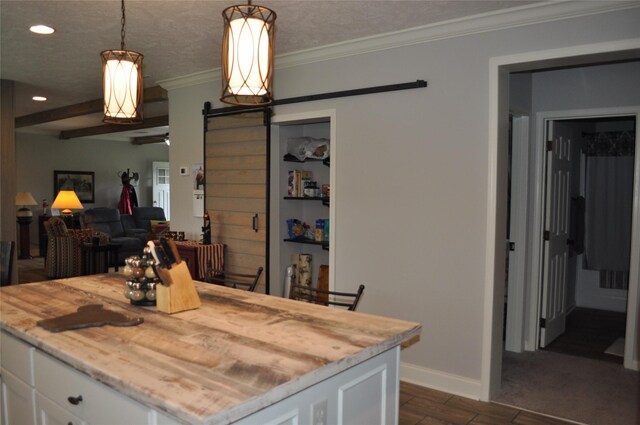 280 Lakewood Cir, Brenham, TX 77833 - kitchen with white cabinets, a barn door, baseboards, recessed lighting, and ornamental molding