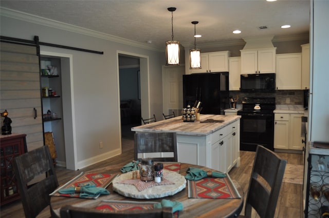 280 Lakewood Cir, Brenham, TX 77833 - kitchen featuring black appliances, wood finished floors, white cabinetry, decorative backsplash, and crown molding