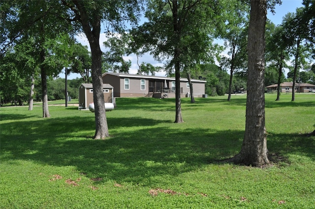280 Lakewood Cir, Brenham, TX 77833 - view of green lawn with a storage unit and an outdoor structure
