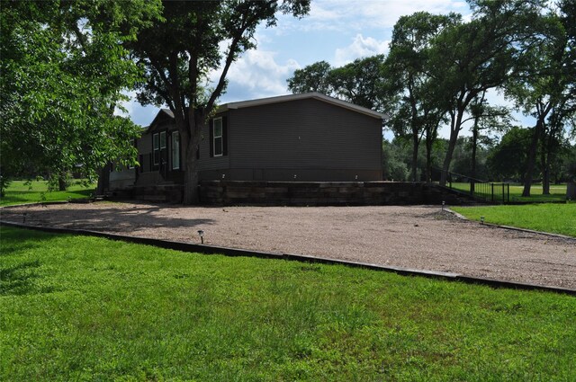 280 Lakewood Cir, Brenham, TX 77833 - rear view of house featuring a yard
