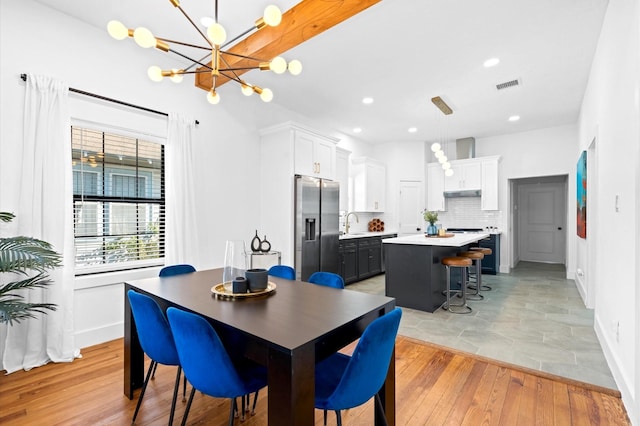 128 N Jenkins St, Houston, TX 77003 - dining area with a chandelier, light wood finished floors, recessed lighting, and baseboards