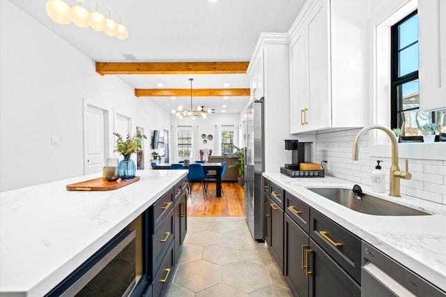 128 N Jenkins St, Houston, TX 77003 - kitchen with a sink, white cabinets, stainless steel appliances, hanging light fixtures, and recessed lighting
