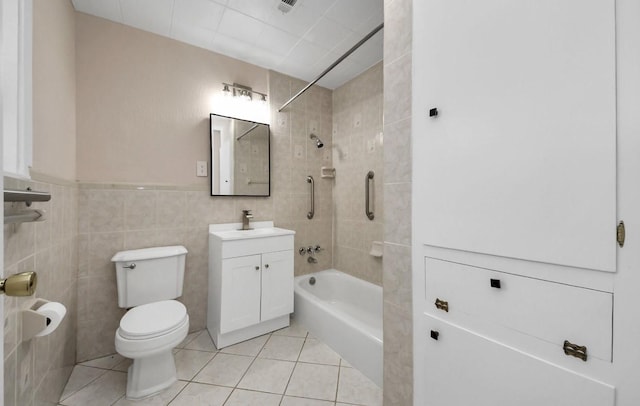 2013 15th Ave N, Texas City, TX 77590 - bathroom featuring washtub / shower combination, tile patterned floors, toilet, vanity, and tile walls
