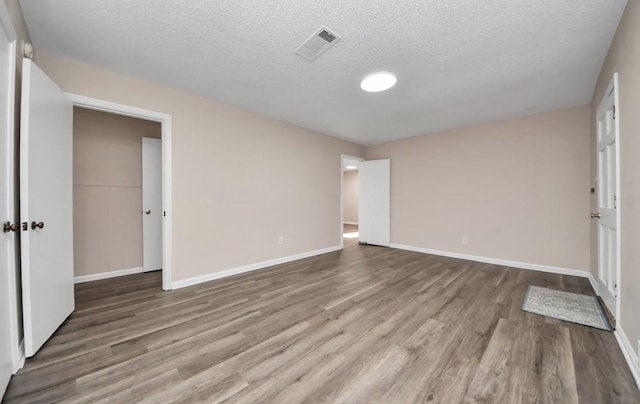 2013 15th Ave N, Texas City, TX 77590 - empty room featuring wood finished floors, a textured ceiling, and baseboards