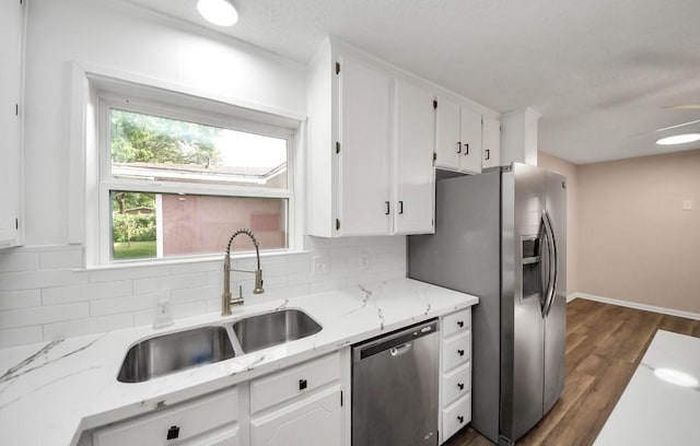 2013 15th Ave N, Texas City, TX 77590 - kitchen with stainless steel appliances, tasteful backsplash, white cabinetry, and a sink