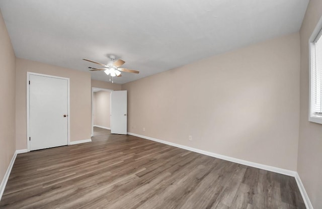 2013 15th Ave N, Texas City, TX 77590 - unfurnished bedroom featuring wood finished floors, baseboards, and a ceiling fan