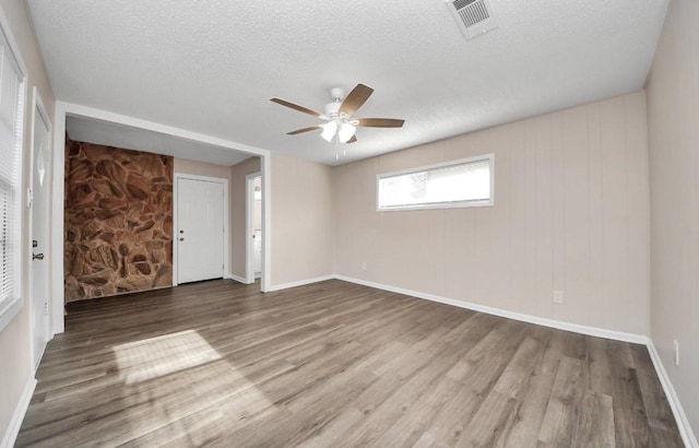 2013 15th Ave N, Texas City, TX 77590 - unfurnished room with a ceiling fan, wood finished floors, a textured ceiling, and baseboards