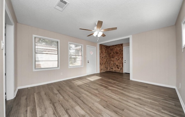 2013 15th Ave N, Texas City, TX 77590 - empty room with ceiling fan, wood finished floors, a textured ceiling, and baseboards