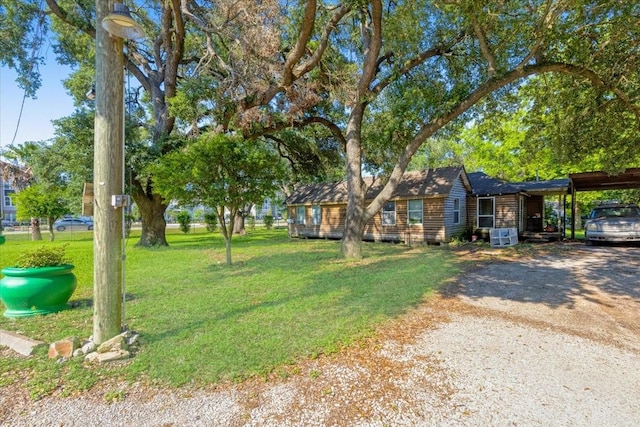 3929 Almeda Genoa Rd, Houston, TX 77047 - log-style house with a front lawn, a carport, and driveway