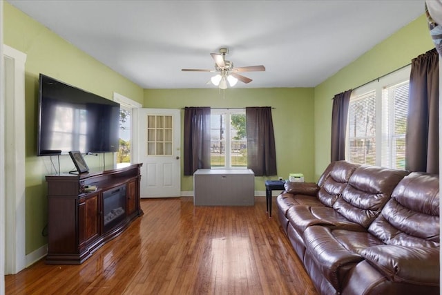 3929 Almeda Genoa Rd, Houston, TX 77047 - living room featuring ceiling fan, hardwood / wood-style flooring, baseboards, and a fireplace