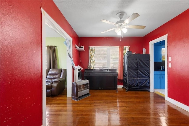 3929 Almeda Genoa Rd, Houston, TX 77047 - bedroom with hardwood / wood-style flooring, a textured wall, baseboards, and ceiling fan