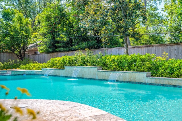 view of pool with a fenced backyard