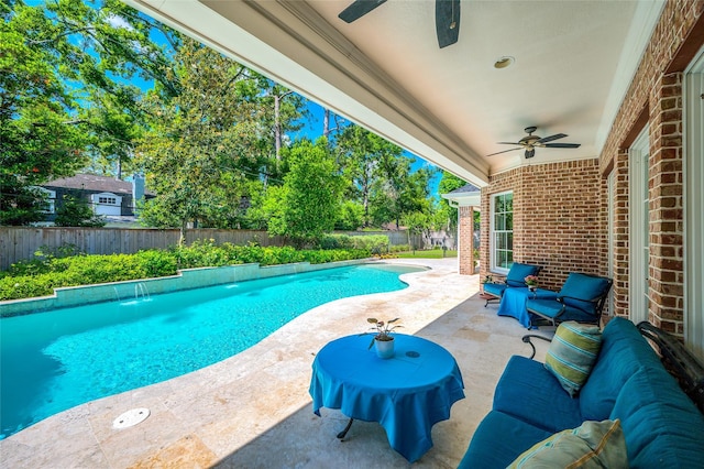 view of swimming pool with ceiling fan, a fenced backyard, and a patio area