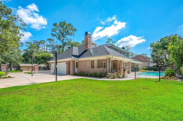 back of property featuring brick siding, concrete driveway, a garage, and a chimney