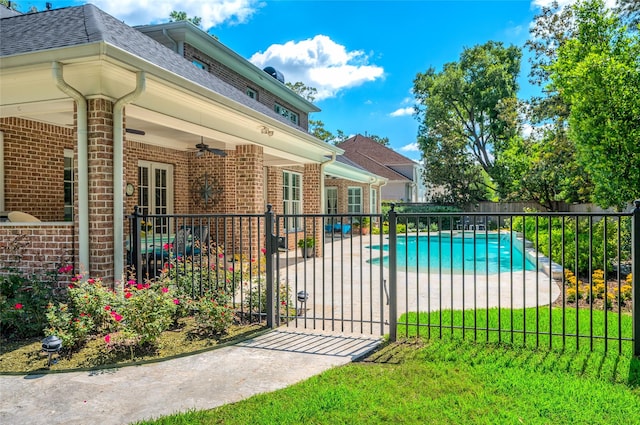 view of swimming pool featuring a patio area and a ceiling fan