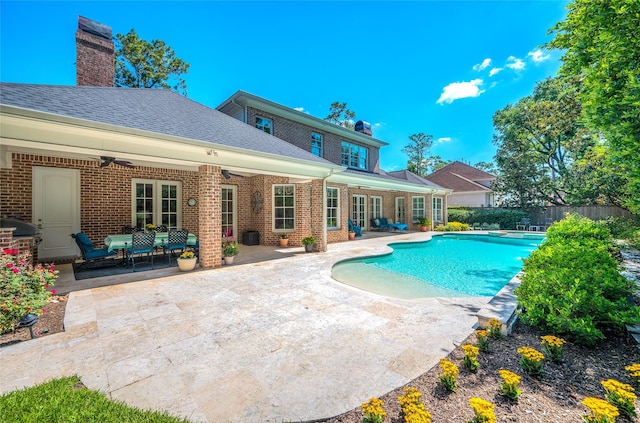 view of pool featuring ceiling fan, a patio area, fence, and area for grilling