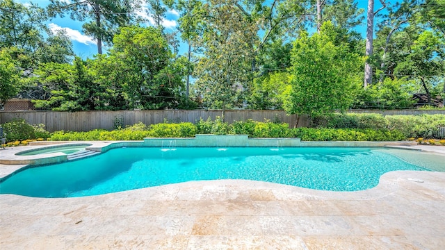 view of swimming pool featuring a fenced backyard, a pool with connected hot tub, and a patio
