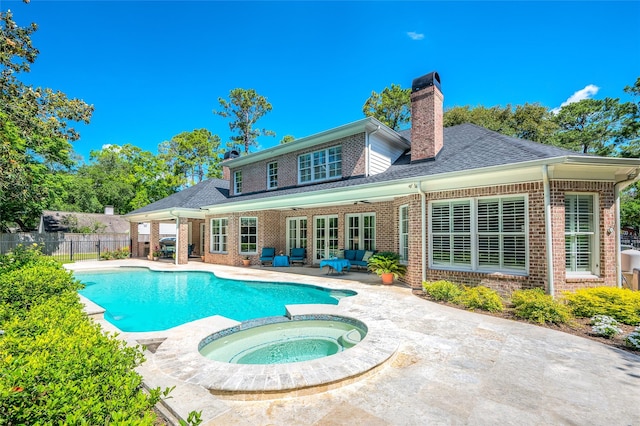 back of house with brick siding, a chimney, a patio area, a ceiling fan, and fence