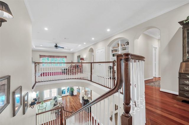 stairway with crown molding, ceiling fan, wood finished floors, recessed lighting, and baseboards