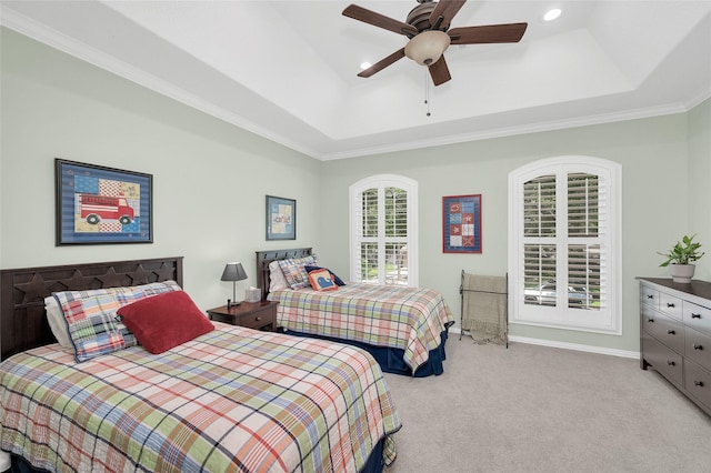 bedroom featuring light colored carpet, a raised ceiling, recessed lighting, ornamental molding, and ceiling fan