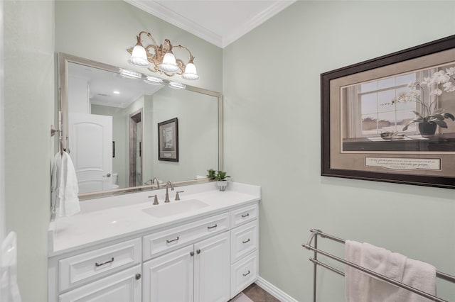 bathroom with crown molding, vanity, and baseboards