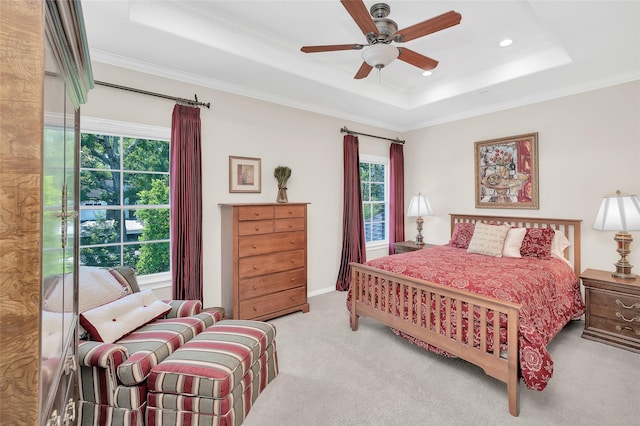 bedroom featuring a tray ceiling, carpet flooring, crown molding, recessed lighting, and a ceiling fan