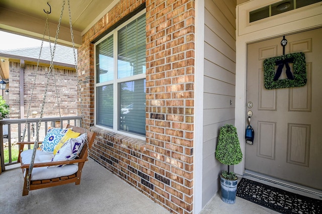 14923 Cutleaf Ln, Cypress, TX 77429 - view of exterior entry featuring brick siding and a porch