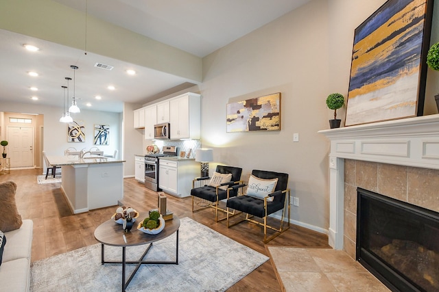 14923 Cutleaf Ln, Cypress, TX 77429 - living area with light wood-style floors, a fireplace, and recessed lighting