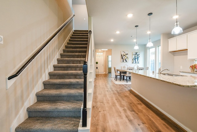14923 Cutleaf Ln, Cypress, TX 77429 - stairs with wood finished floors and recessed lighting