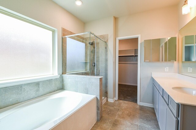14923 Cutleaf Ln, Cypress, TX 77429 - bathroom featuring vanity, a shower stall, a bath, a walk in closet, and recessed lighting
