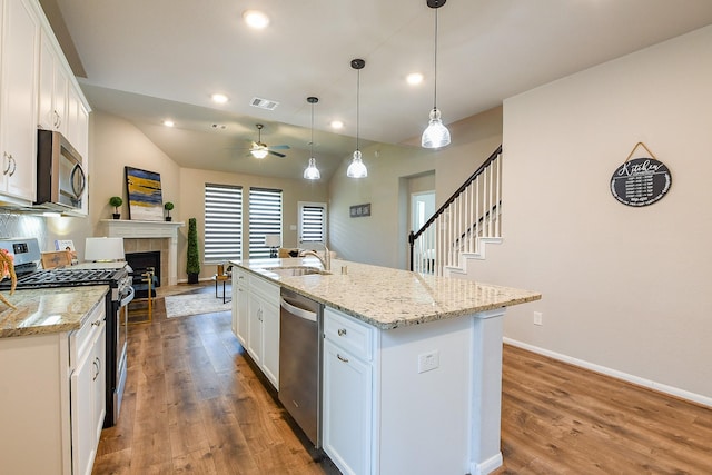 14923 Cutleaf Ln, Cypress, TX 77429 - kitchen with appliances with stainless steel finishes, a ceiling fan, dark wood finished floors, white cabinets, and recessed lighting