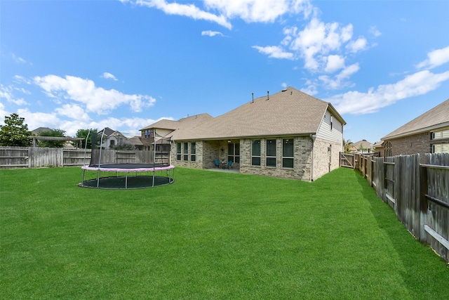 19115 Blooms Rise Dr, Tomball, TX 77377 - rear view of house featuring a trampoline and brick siding